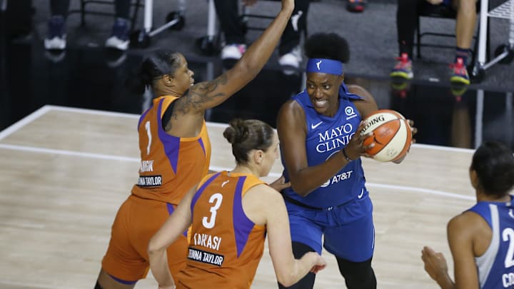 Sep 17, 2020; Bradenton, Florida, USA; Minnesota Lynx forward Damiris Dantas (12) drives to the basket around Phoenix Mercury guard Diana Taurasi (3) and Phoenix Mercury center Kia Vaughn (1) during the first half at the FELD Entertainment complex. Mandatory Credit: Reinhold Matay-Imagn Images