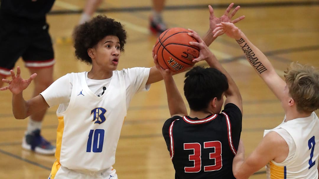 Bremerton   s Jalen Davis (10) and Trenton Bulmer (2) put the pressure on Shelton   s Weetly Cordova (33) during their game on Monday, Dec. 11, 2023.