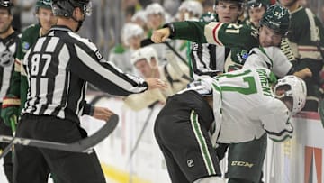 Oct 7, 2023; Saint Paul, Minnesota, USA; Minnesota Wild forward Brandon Duhaime (21) and Dallas Stars forward Mason Marchment (27) fight during the third period at Xcel Energy Center. Mandatory Credit: Nick Wosika-Imagn Images


