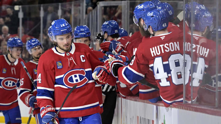 Apr 8, 2025; Montreal, Quebec, CAN; Montreal Canadiens forward Nick Suzuki (14) celebrates with teammates after scoring a goal against the Detroit Red Wings during the third period at the Bell Centre. Mandatory Credit: Eric Bolte-Imagn Images
