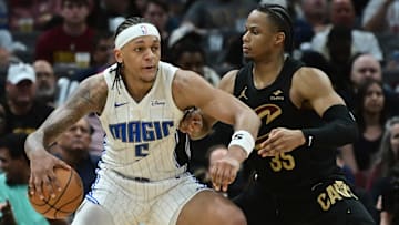 Apr 30, 2024; Cleveland, Ohio, USA; Cleveland Cavaliers forward Isaac Okoro (35) defends Orlando Magic forward Paolo Banchero (5) during the second half in game five of the first round for the 2024 NBA playoffs at Rocket Mortgage FieldHouse. Mandatory Credit: Ken Blaze-Imagn Images