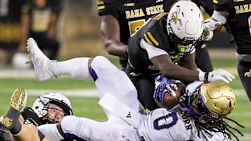 Alabama State linebacker Colton Adams (1) and defensive back Adrian Maddox (14) stop Alcorn running back Jargon Howard (0) during their game at Hornet Stadium in Montgomery, Ala., on Saturday September 30, 2023.