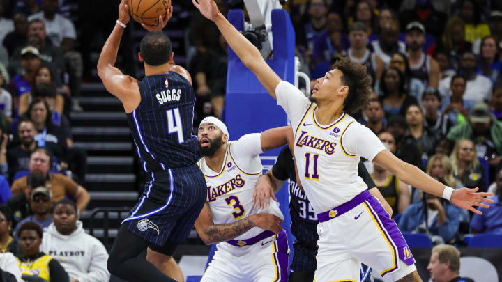 Nov 4, 2023; Orlando, Florida, USA; Orlando Magic guard Jalen Suggs (4) shoots the ball against Los Angeles Lakers forward Anthony Davis (3) and center Jaxson Hayes (11) during the first quarter at Amway Center. Mandatory Credit: Mike Watters-USA TODAY Sports