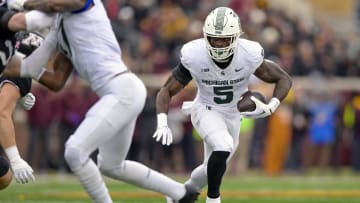 Oct 28, 2023; Minneapolis, Minnesota, USA; Michigan State Spartans running back Nate Carter (5) runs with the ball against the Minnesota Golden Gophers during the first quarter at Huntington Bank Stadium. Mandatory Credit: Nick Wosika-USA TODAY Sports