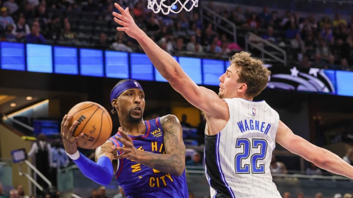 Denver Nuggets guard Kentavious Caldwell-Pope (5) passes the ball around Orlando Magic forward Franz Wagner (22) during the second quarter at Amway Center. 