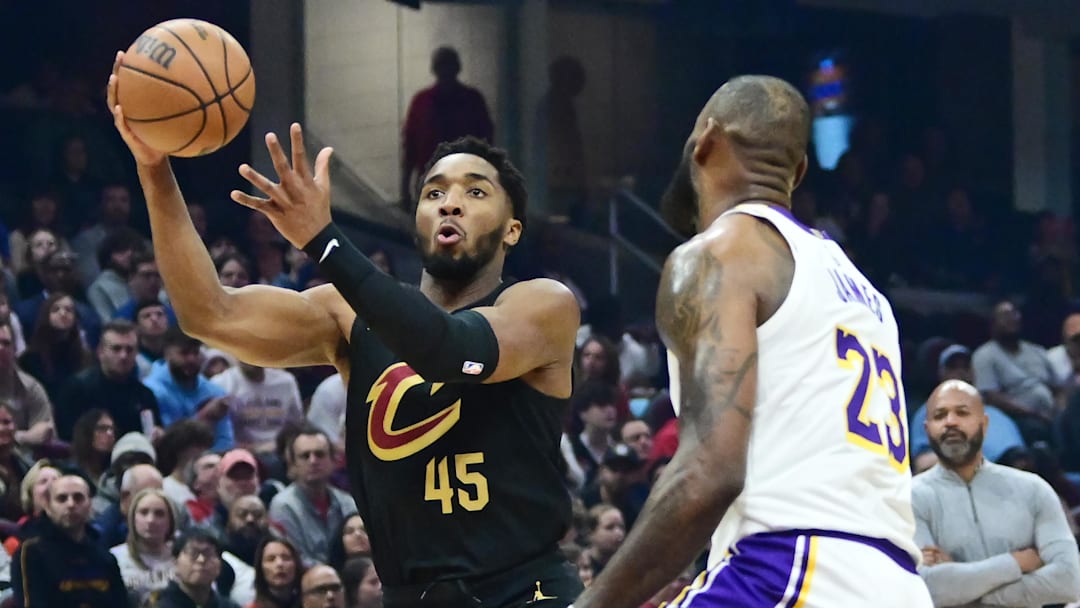 Nov 25, 2023; Cleveland, Ohio, USA; Cleveland Cavaliers guard Donovan Mitchell (45) drives to the basket against Los Angeles Lakers forward LeBron James (23) during the first half at Rocket Mortgage FieldHouse. Mandatory Credit: Ken Blaze-Imagn Images