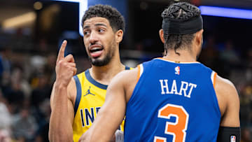 Nov 10, 2024; Indianapolis, Indiana, USA;  Indiana Pacers guard Tyrese Haliburton (0) celebrates a call in the while talking to New York Knicks guard Josh Hart (3) during the second half  at Gainbridge Fieldhouse. Mandatory Credit: Trevor Ruszkowski-Imagn Images