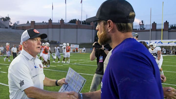 Mercer head coach Drew Cronic, left, greets North Alabama head coach Brent Dearmon after the FCS Kickoff held at Cramton Bowl in Montgomery, Ala., on Saturday August 26, 2023.