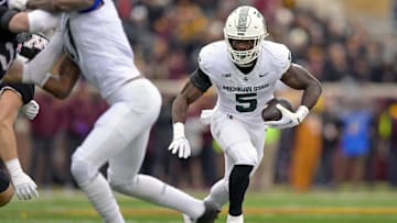 Oct 28, 2023; Minneapolis, Minnesota, USA; Michigan State Spartans running back Nate Carter (5) runs with the ball against the Minnesota Golden Gophers during the first quarter at Huntington Bank Stadium. Mandatory Credit: Nick Wosika-Imagn Images