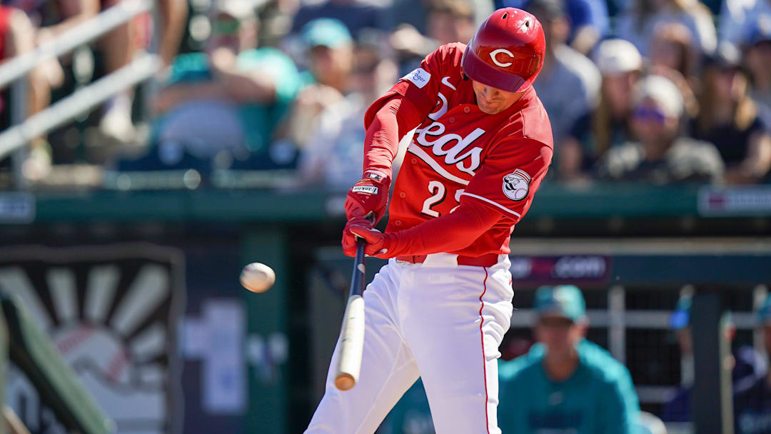 Cincinnati Reds left fielder JJ Bleday (22) hits a double RBI in the second inning of a Cactus League game between the Cincinnati Reds and Seattle Mariners, Sunday, Feb. 22, 2026, at Goodyear Ballpark in Goodyear, Ariz.