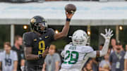 Sep 30, 2023; Orlando, Florida, USA; UCF Knights quarterback Timmy McClain (9) throws a pass in front of Baylor Bears safety Devyn Bobby (28) during the second half at FBC Mortgage Stadium. Mandatory Credit: Mike Watters-Imagn Images