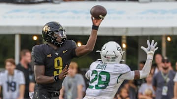 Sep 30, 2023; Orlando, Florida, USA; UCF Knights quarterback Timmy McClain (9) throws a pass in front of Baylor Bears safety Devyn Bobby (28) during the second half at FBC Mortgage Stadium. Mandatory Credit: Mike Watters-Imagn Images