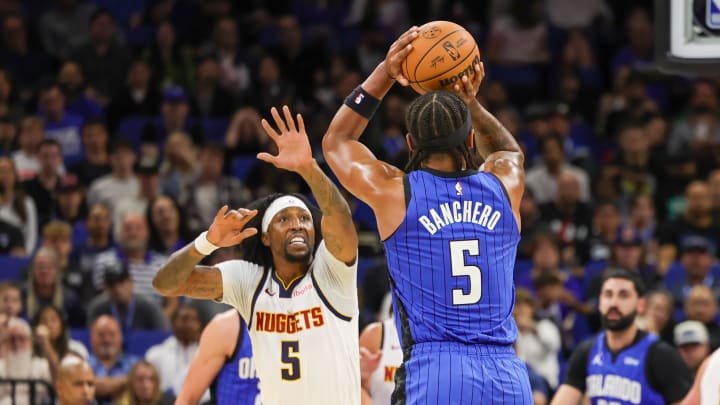 Nov 22, 2023; Orlando Magic forward Paolo Banchero (5) shoots the ball against then-Denver Nuggets guard Kentavious Caldwell-Pope (5) during the first quarter at Amway Center.