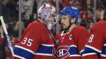 Apr 5, 2025; Montreal, Quebec, CAN; Montreal Canadiens goalie Sam Montembeault (35) and teammate forward Nick Suzuki (14) celebrate the win against the Philadelphia Flyers at the Bell Centre. Mandatory Credit: Eric Bolte-Imagn Images