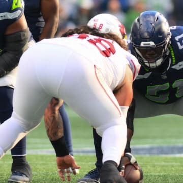 Oct 22, 2023; Seattle, Washington, USA; Seattle Seahawks center Olu Oluwatimi prepares to snap during the second half against the Arizona Cardinals at Lumen Field. Mandatory Credit: Steven Bisig-USA TODAY Sports