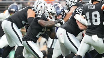 Dec 7, 2025; Paradise, Nevada, USA;  Las Vegas Raiders running back Ashton Jeanty (2) carries the ball against the Denver Broncos during the first half at Allegiant Stadium. Mandatory Credit: Stephen R. Sylvanie-Imagn Images