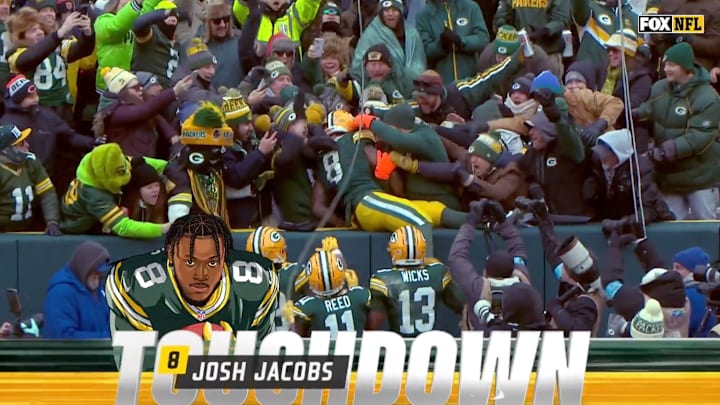 Green Bay Packers running back Josh Jacobs does the Lambeau Leap after scoring a touchdown. Green Bay Packers running back Josh Jacobs does the Lambeau Leap after scoring a touchdown.