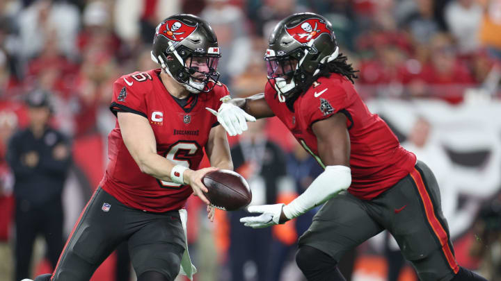 Jan 15, 2024; Tampa, Florida, USA; Tampa Bay Buccaneers quarterback Baker Mayfield (6) hands off the ball to Tampa Bay Buccaneers running back Rachaad White (1) during the first half of a 2024 NFC wild card game against the Philadelphia Eagles at Raymond James Stadium. Mandatory Credit: Nathan Ray Seebeck-USA TODAY Sports