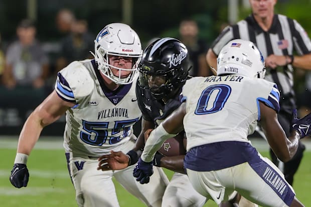 UCF Knights quarterback Timmy McClain carries the ball against Villanova Wildcats defensive back Isas Waxter