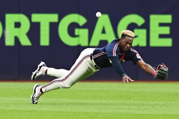 Angel Martinez misplays a ball in center field, allowing it to get past him 