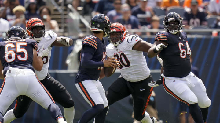 Aug 17, 2024; Chicago, Illinois, USA; Cincinnati Bengals defensive tackle Kris Jenkins Jr. (90) breaks through a block from Chicago Bears guard Nate Davis (64) to sack quarterback Caleb Williams (18) in the second quarter at Soldier Field. Mandatory Credit: Sam Greene-USA TODAY Sports