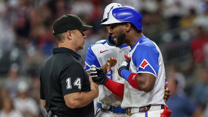 Sep 27, 2025; Cumberland, Georgia, USA; Atlanta Braves outfielder Jurickson Profar (7) speaks to umpire Mark Wegner (14) after a call in the game against the Pittsburgh Pirates during the eighth inning at Truist Park. Mandatory Credit: Jordan Godfree-Imagn Images