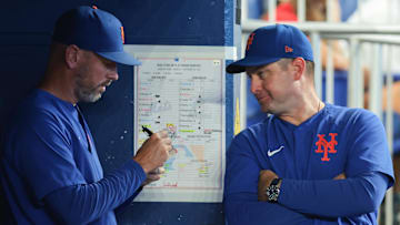 Sep 28, 2025; Miami, Florida, USA; New York Mets manager Carlos Mendoza (64) talks to pitching coach Jeremy Hefner (95) against the Miami Marlins during the eighth inning at loanDepot Park. Mandatory Credit: Sam Navarro-Imagn Images