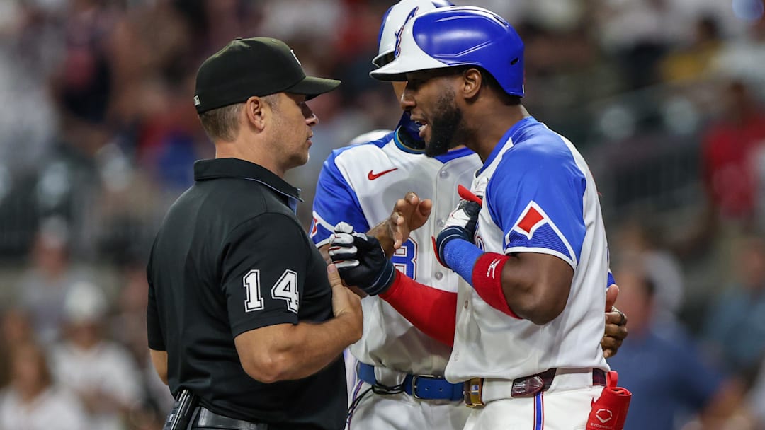 Sep 27, 2025; Cumberland, Georgia, USA; Atlanta Braves outfielder Jurickson Profar (7) speaks to umpire Mark Wegner (14) after a call in the game against the Pittsburgh Pirates during the eighth inning at Truist Park.
