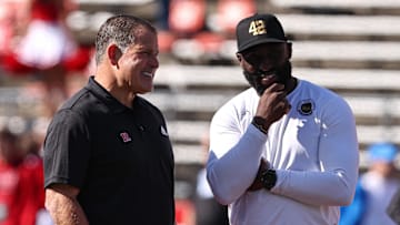 Oct 19, 2024; Piscataway, New Jersey, USA; Rutgers Scarlet Knights head coach Greg Schiano, left, talks with UCLA Bruins head coach DeShaun Foster before their Big Ten conference game at SHI Stadium. Mandatory Credit: Vincent Carchietta-Imagn Images