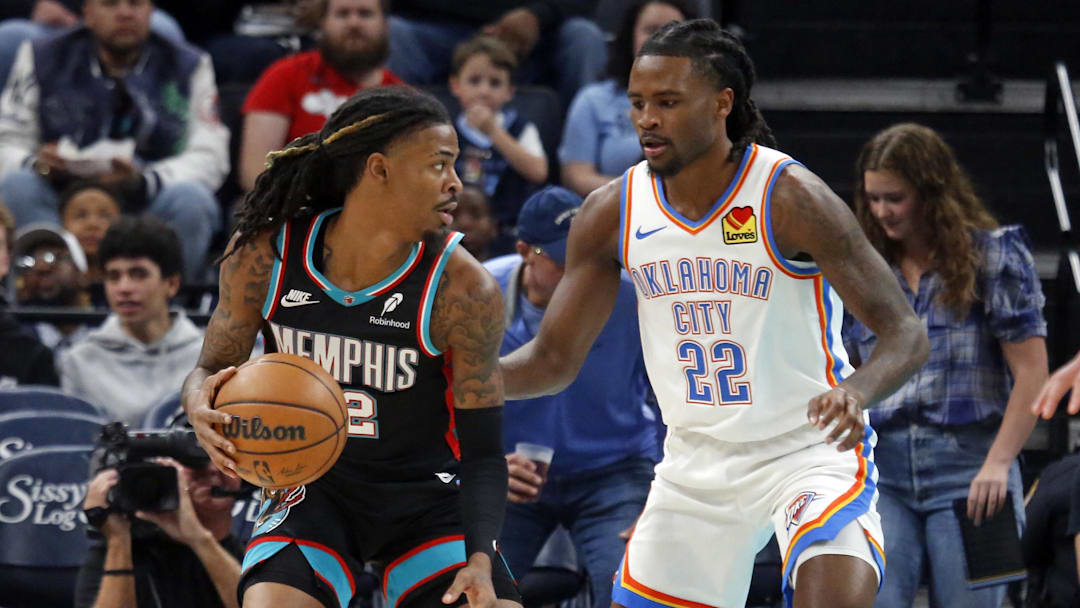 Nov 9, 2025; Memphis, Tennessee, USA; Memphis Grizzlies guard Ja Morant (12) dribbles as Oklahoma City Thunder guard Cason Wallace (22) defends during the first quarter at FedExForum. Mandatory Credit: Petre Thomas-Imagn Images