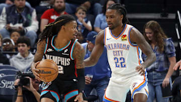 Nov 9, 2025; Memphis, Tennessee, USA; Memphis Grizzlies guard Ja Morant (12) dribbles as Oklahoma City Thunder guard Cason Wallace (22) defends during the first quarter at FedExForum.