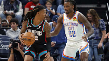Nov 9, 2025; Memphis, Tennessee, USA; Memphis Grizzlies guard Ja Morant (12) dribbles as Oklahoma City Thunder guard Cason Wallace (22) defends during the first quarter at FedExForum. Mandatory Credit: Petre Thomas-Imagn Images