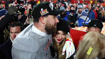 Jan 26, 2025; Kansas City, MO, USA; Recording artist Taylor Swift  and Kansas City Chiefs tight end Travis Kelce (87) react after the AFC Championship game against the Buffalo Bills at GEHA Field at Arrowhead Stadium. 