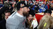 Jan 26, 2025; Kansas City, MO, USA; Recording artist Taylor Swift  and Kansas City Chiefs tight end Travis Kelce (87) react after the AFC Championship game against the Buffalo Bills at GEHA Field at Arrowhead Stadium. Mandatory Credit: Mark J. Rebilas-Imagn Images
