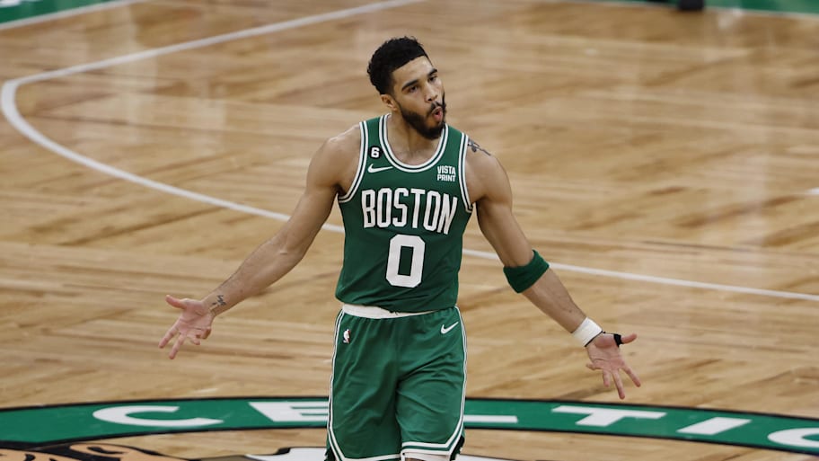 Celtics forward Jayson Tatum celebrates after making a three-point basket against the 76ers.