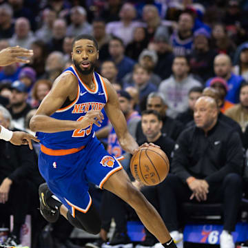 Jan 15, 2025; Philadelphia, Pennsylvania, USA; New York Knicks forward Mikal Bridges (25) dribbles the ball against Philadelphia 76ers forward Guerschon Yabusele (28) during the second quarter at Wells Fargo Center. Mandatory Credit: Bill Streicher-Imagn Images