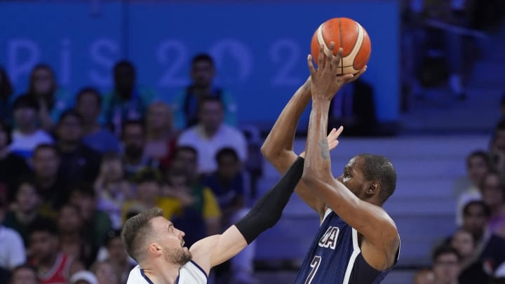 Jul 28, 2024; Villeneuve-d'Ascq, France; United States guard Kevin Durant (7) shoots against Serbia shooting guard Marko Guduric (23) in the fourth quarter during the Paris 2024 Olympic Summer Games at Stade Pierre-Mauroy. Mandatory Credit: John David Mercer-USA TODAY Sports