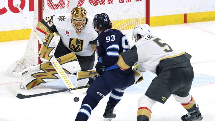 Mar 24, 2026; Winnipeg, Manitoba, CAN; Winnipeg Jets center Brad Lambert (93) shoots on Vegas Golden Knights goaltender Adin Hill (33) in the third period at Canada Life Centre. Mandatory Credit: James Carey Lauder-Imagn Images