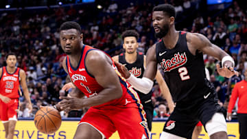 Mar 16, 2024; New Orleans, Louisiana, USA;  New Orleans Pelicans forward Zion Williamson (1) dribbles against Portland Trail Blazers center Deandre Ayton (2) during the second half at Smoothie King Center. Mandatory Credit: Stephen Lew-Imagn Images