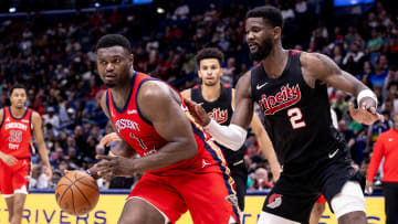 Mar 16, 2024; New Orleans, Louisiana, USA;  New Orleans Pelicans forward Zion Williamson (1) dribbles against Portland Trail Blazers center Deandre Ayton (2) during the second half at Smoothie King Center.