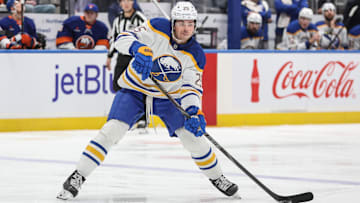 Dec 23, 2024; Elmont, New York, USA;  Buffalo Sabres defenseman Owen Power (25) looks to make a pass in the first period against the New York Islanders at UBS Arena. Mandatory Credit: Wendell Cruz-Imagn Images