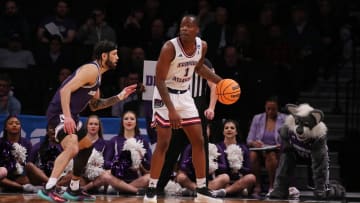 March 22, 2024, Brooklyn, NY, USA; Florida Atlantic Owls guard Johnell Davis (1) is defended by Northwestern Wildcats guard Boo Buie (0) in the first round of the 2024 NCAA Tournament at the Barclays Center. Mandatory Credit: Brad Penner-USA TODAY Sports