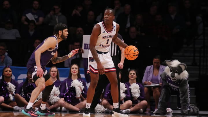 March 22, 2024, Brooklyn, NY, USA; Florida Atlantic Owls guard Johnell Davis (1) is defended by Northwestern Wildcats guard Boo Buie (0) in the first round of the 2024 NCAA Tournament at the Barclays Center. Mandatory Credit: Brad Penner-USA TODAY Sports