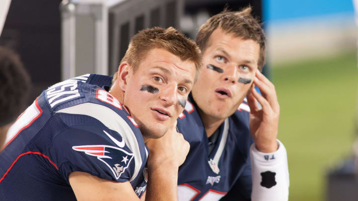 New England Patriots tight end Rob Gronkowski (87) and quarterback Tom Brady (12) sit on the bench during the second half against the Carolina Panthers at Bank of America Stadium in Charlotte, N.C., on Aug. 28, 2015.