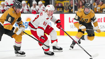 Nov 11, 2024; Las Vegas, Nevada, USA; Carolina Hurricanes right wing Jackson Blake (53) controls the puck ahead of Vegas Golden Knights defenseman Kaedan Korczak (6) during the first period at T-Mobile Arena. Mandatory Credit: Stephen R. Sylvanie-Imagn Images