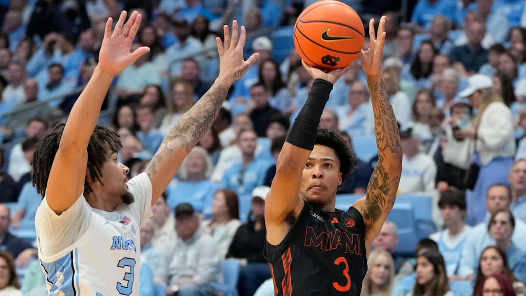 Mar 1, 2025; Chapel Hill, North Carolina, USA;  Miami (Fl) Hurricanes guard Jalil Bethea (3) shoots as North Carolina Tar Heels guard Elliot Cadeau (3) defends in the first half at Dean E. Smith Center. Mandatory Credit: Bob Donnan-Imagn Images