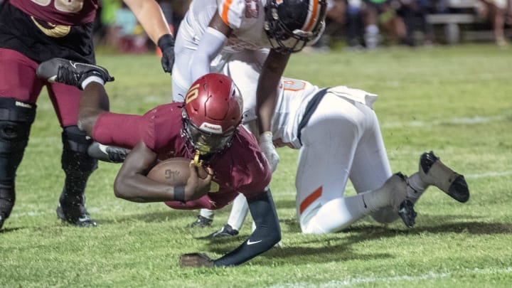 Lake Gibson quarterback Joel Morris (10) is tackled by Lakeland defenisve end Greg Dickens on Friday night at Virgil Ramage Stadium.