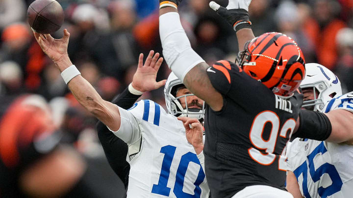 Indianapolis Colts quarterback Gardner Minshew II (10) throws a pass while being covered by Cincinnati Bengals defensive tackle BJ Hill (92) on Sunday, Dec. 10, 2023, during a game against the Cincinnati Bengals at Paycor Stadium in Cincinnati.