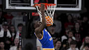 Feb 2, 2025; Cincinnati, Ohio, USA;  West Virginia Mountaineers center Eduardo Andre (0) dunks the ball against the Cincinnati Bearcats in the first half at Fifth Third Arena. Mandatory Credit: Aaron Doster-Imagn Images