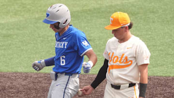 Tennessee's Ariel Antigua (2) taps Kentucky's Tyler Bell (6) with the ball as he celebrates hitting a double during an NCAA college baseball game on April 20, 2025, in Knoxville, Tenn.